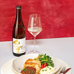Heiwa “KID” Junmai, with a wine glass, served with a ginger pork with egg tartar sauce