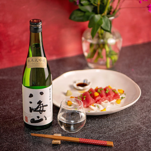 Hakkaisan “Junmai Daiginjo”, with a clear glass cup, served with tuna sashimi